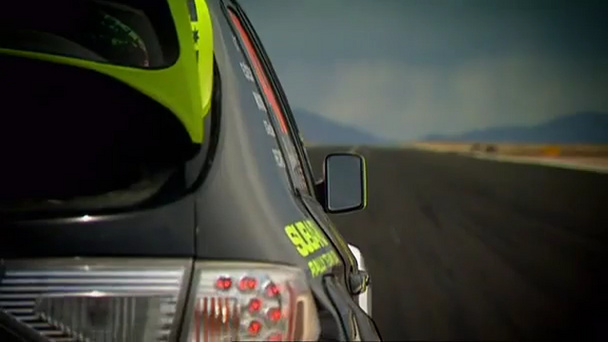 Ken Block is racing Ricky Carmichael on an air strip in California.