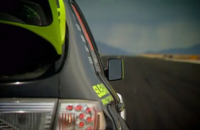Ken Block is racing Ricky Carmichael on an air strip in California.