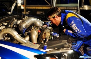 Subaru Rally Team USA tech from Vermont SportsCar inspects Pastrana\'s car
